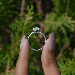 Back View of Oval Moonstone Gemstone Solitaire Ring In two fingers