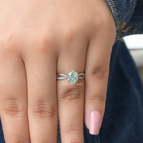 [In finger front view of blue oval cut moissanite engagement ring made of 14k white gold]-[Golden Bird Jewels]