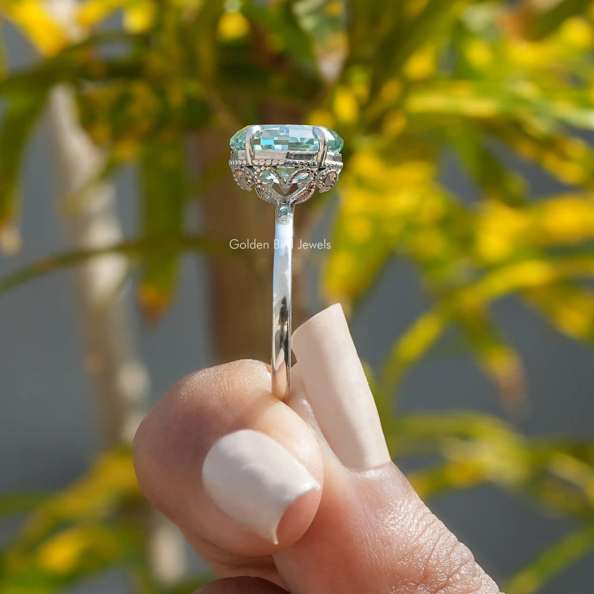 Side View of Step Cut Oval Hidden Halo Solitaire Ring In two fingers