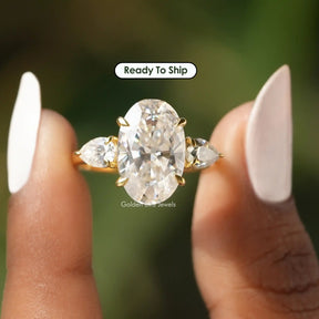 [Front view of oval three stone engagement ring made of pear cut side stones]-[Golden Bird Jewels]