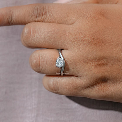Close-up of pear-cut moissanite solitaire ring on finger