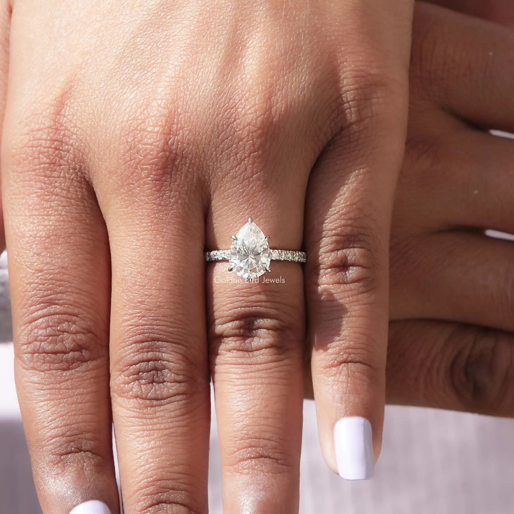 [In finger front view of pear shaped moissanite ring made of round cut stones]-[Golden Bird Jewels]