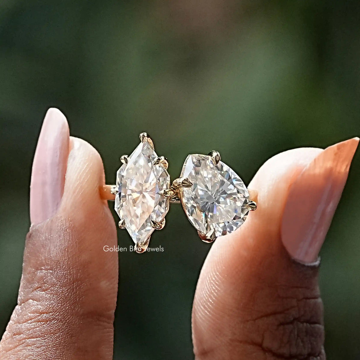 Front View of Pear And Dutch Marquise Moissanite Toi Et Moi Ring In two Fingers