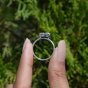 Back View of Pear And Radiant Cut Moissanite Engagement Ring In two fingers