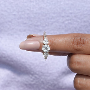 In finger front View of Round Cut Lab Diamond Three Stone Engagement Ring In Yellow Gold