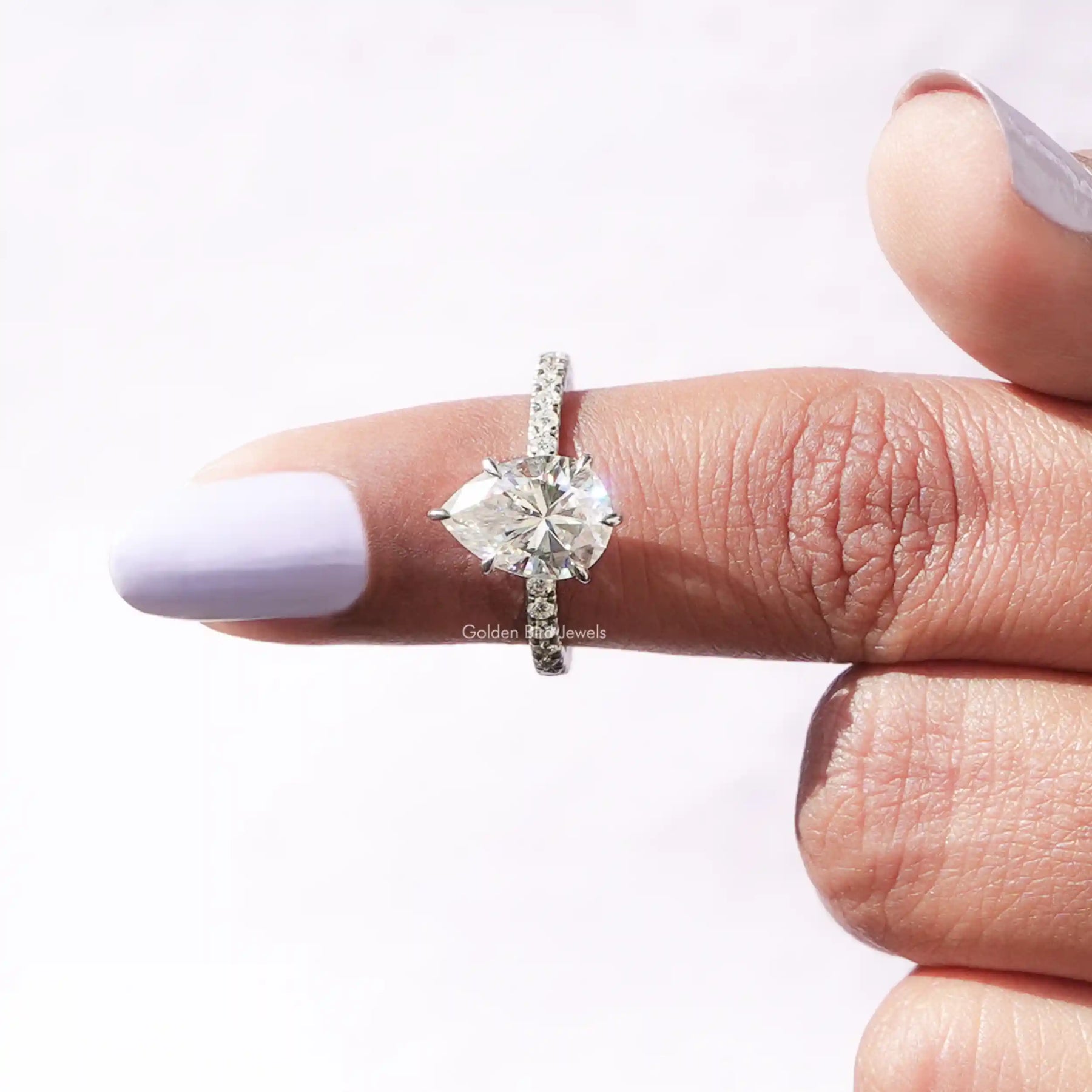 [This pear cut moissanite ring made of 14k white gold and prong setting]-[Golden Bird Jewels]