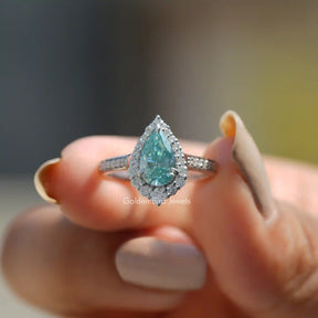 Front View of Pear Cut Halo Moissanite Engagement Ring In Two Fingers