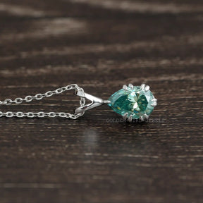 Side view of pear cut moissanite solitaire pendant