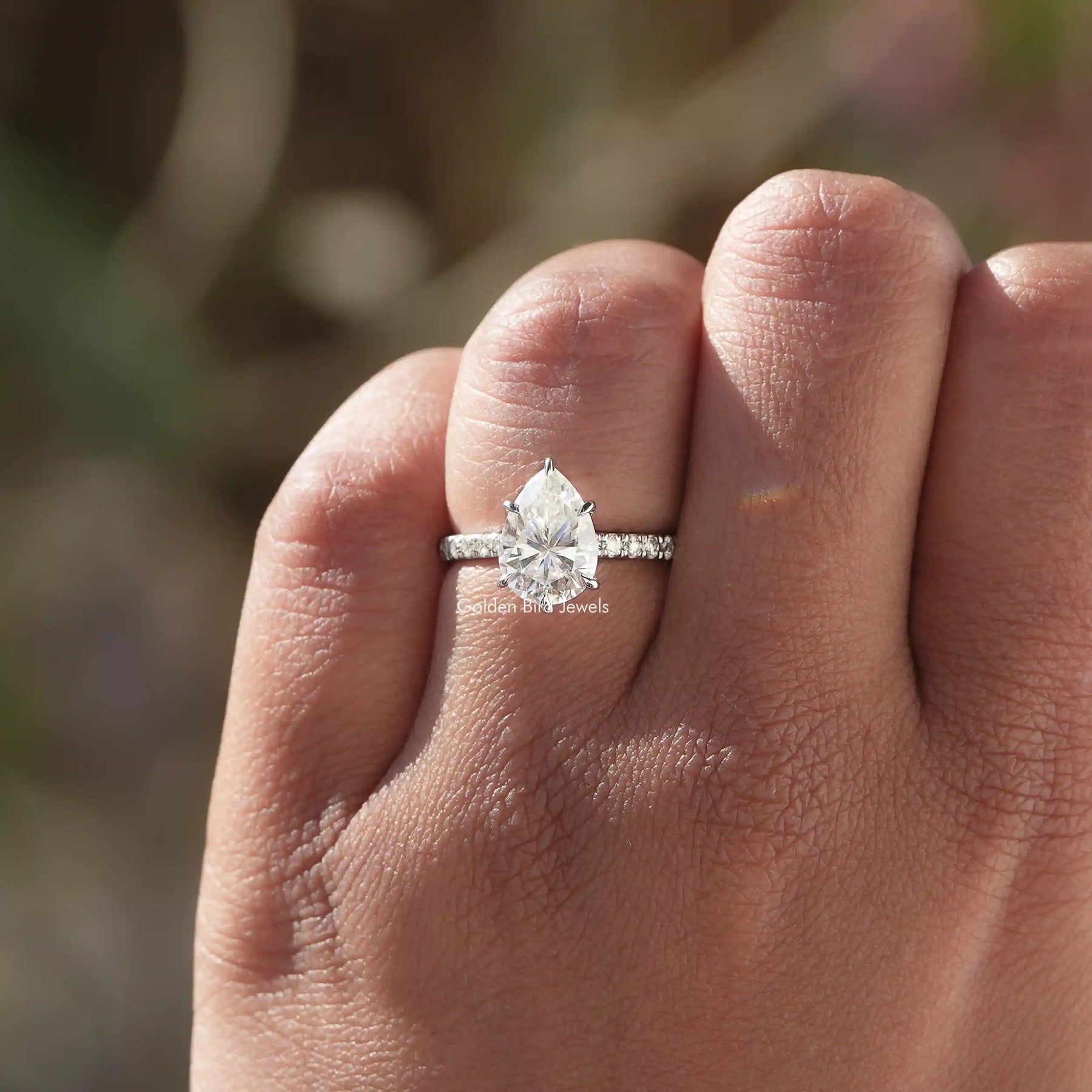 [In finger front view of pear shaped accent stone ring made of vvs clarity and 14k white gold]-[Golden Bird Jewels]