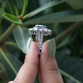 Side View of Double Halo Pear Shaped Moissanite Ring In two fingers