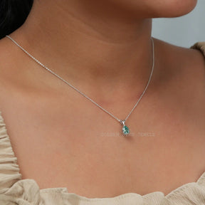 [In neck side view of blue pear cut moissanite pendant]-[Golden Bird Jewels]