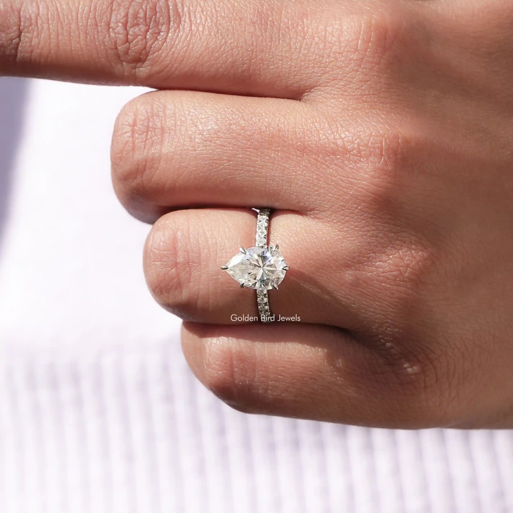 [In finger front view of 14k white gold pear shaped moissanite ring]-[Golden Bird Jewels]