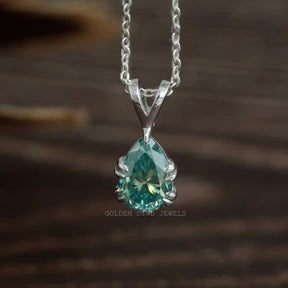Front view of blue pear cut moissanite pendant made of double claw setting