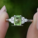 Front view of Peridot Green Emerald Gemstone Ring in two fingers 