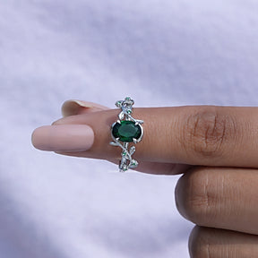 In finger front View of Oval Cut Gemstone Accent Stone Ring In White Gold