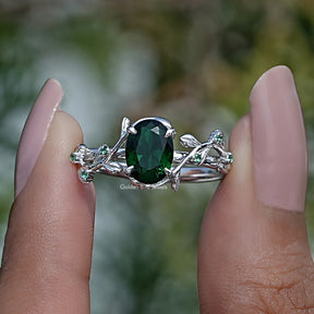 Two fingers holding the Peridot Green Oval Cut Gemstone Ring