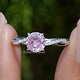 Front view of Pink Tourmaline Round Gemstone Accent Ring in two fingers 