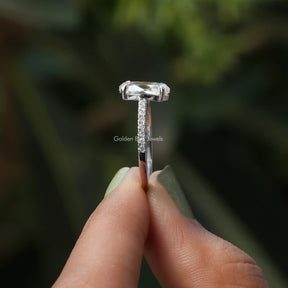 Side View of Moissanite Oval And Round Cut Ring In two fingers