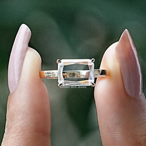Front View of Radiant Cut Moissanite Solitaire Ring In two Fingers