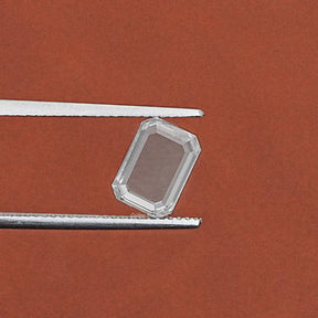 Tweezer holding the Portrait Emerald Cut Loose Lab Diamond