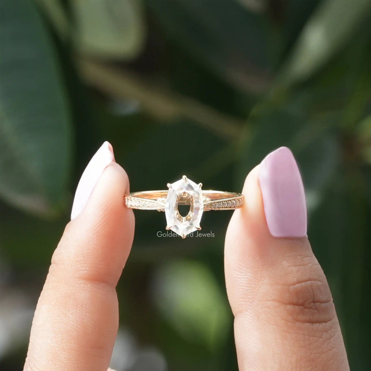 Two fingers holding the Portrait Hexagon Cut Moissanite Ring 