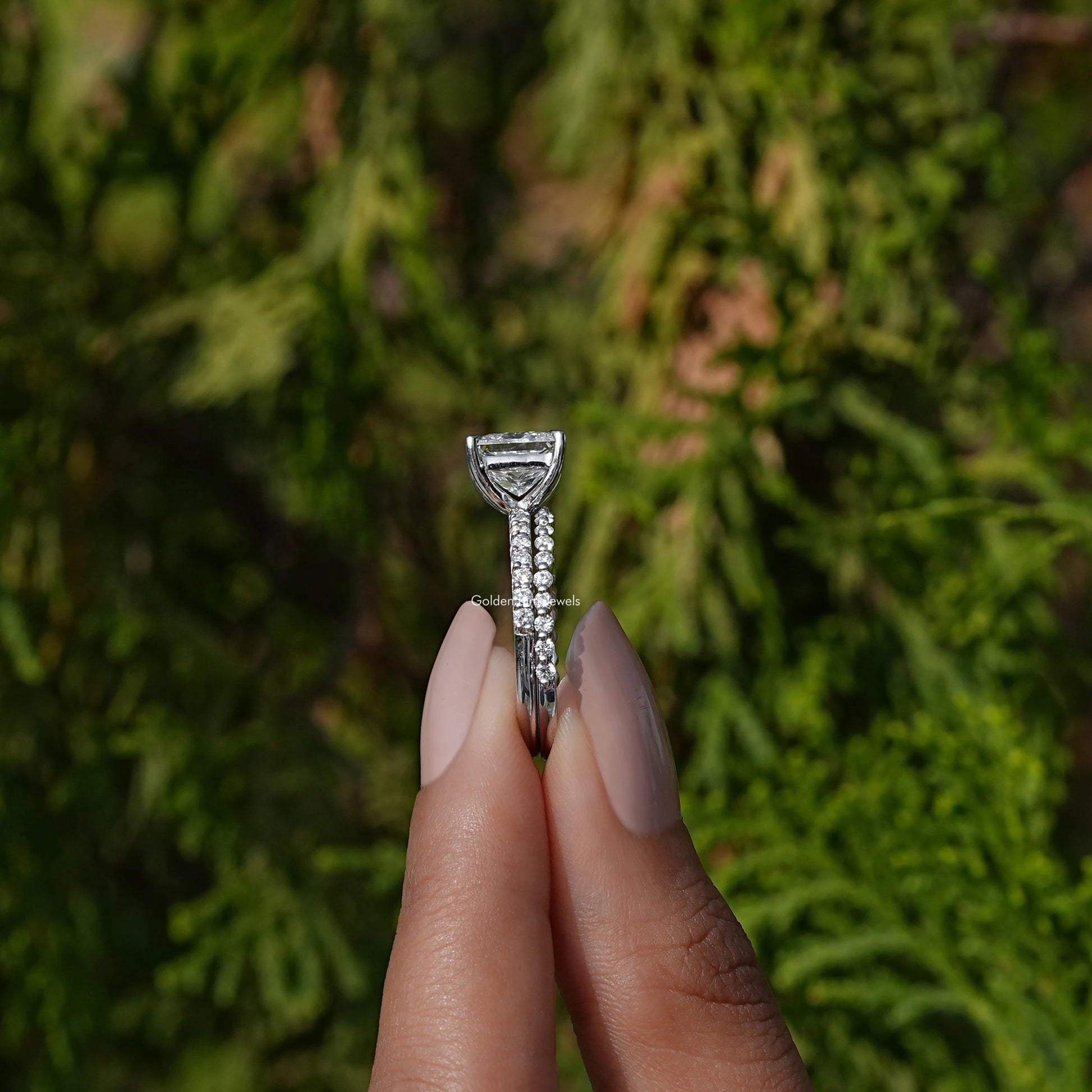 Side View A Princess Cut Lab  Diamond Ring in a two fingers
