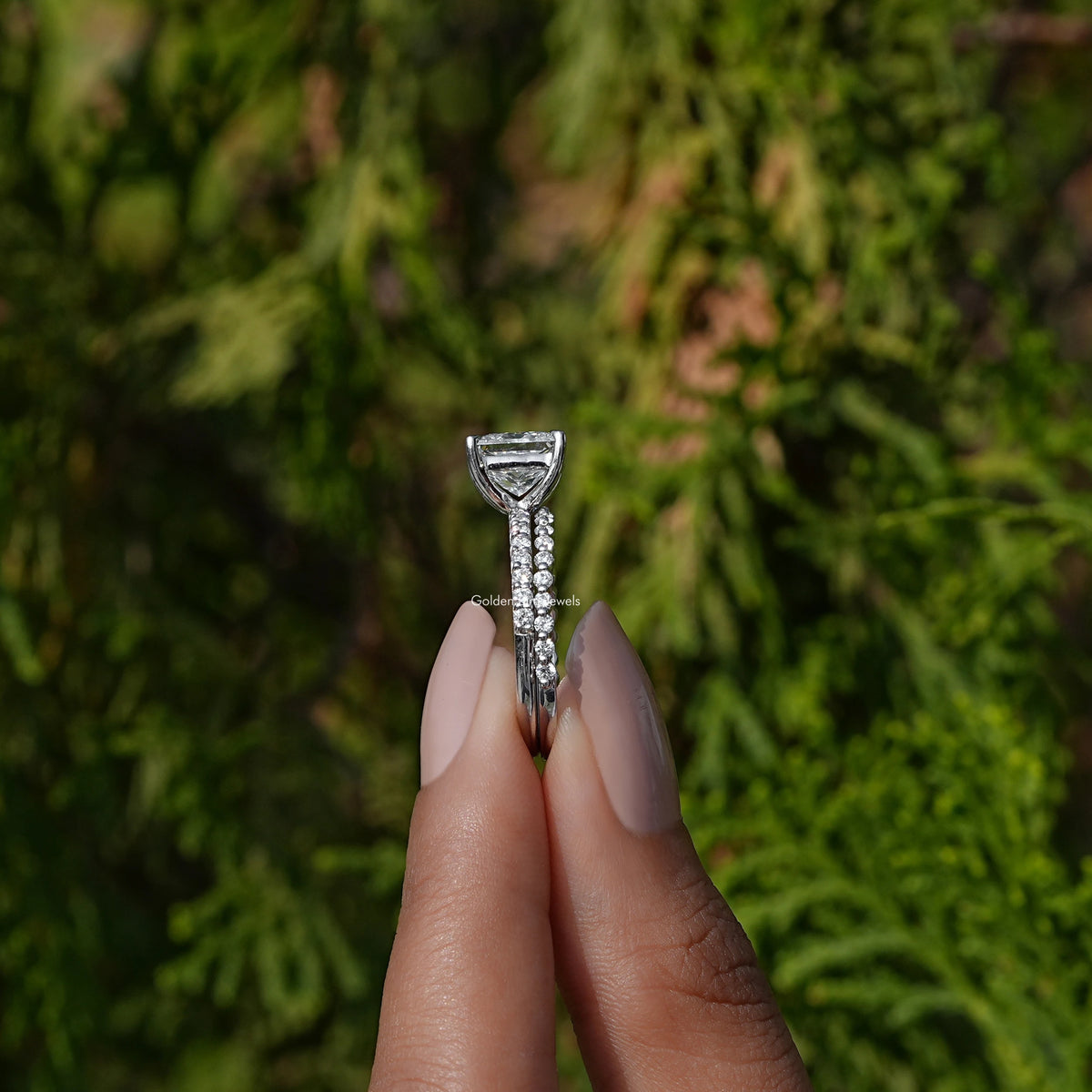 Side View A Princess Cut Lab  Diamond Ring in a two fingers
