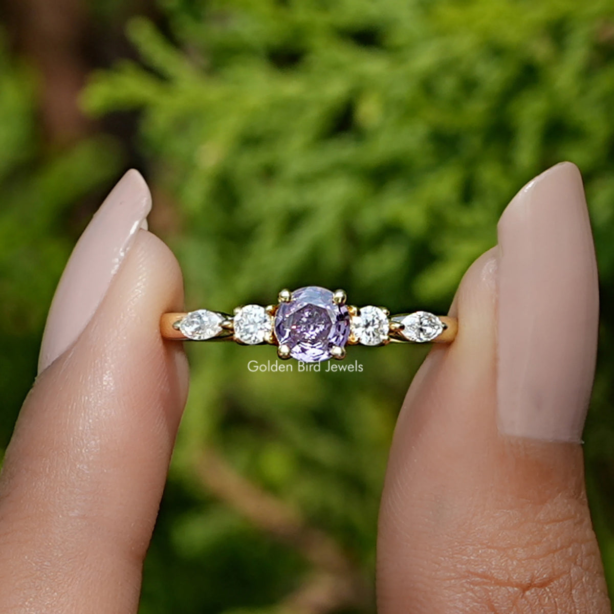 Front View of Round Cut Gemstone Accent Ring In two Fingers