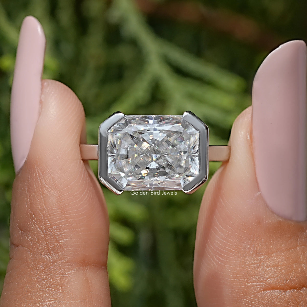 Radiant-cut moissanite solitaire ring with half-bezel setting in silver-tone band