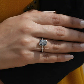 [Cross finger front view of grey radiant cut moissanite ring made of double prong setting]