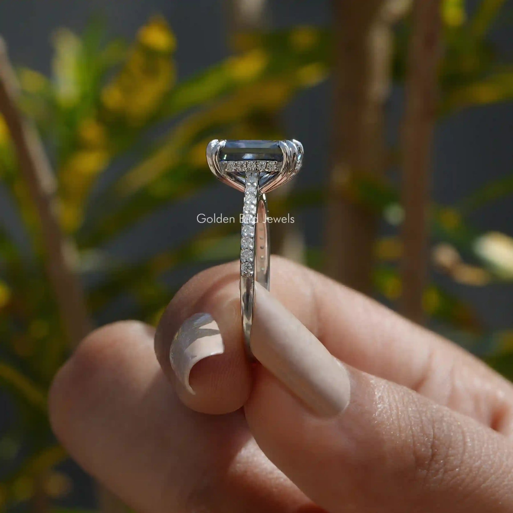[Grey radiant cut moissanite hidden halo engagement ring with side round cut stones]