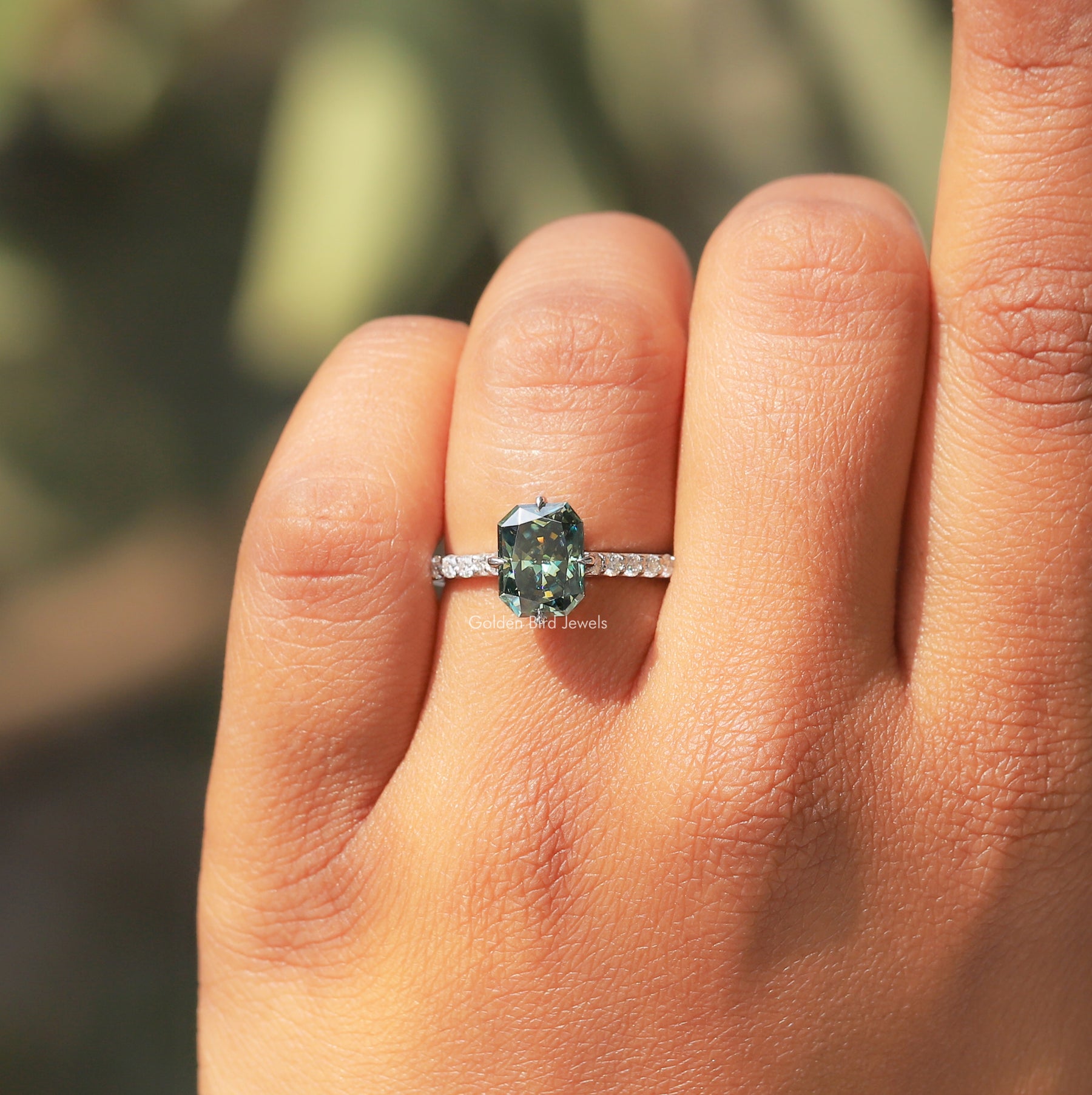 [In finger front view of green radiant cut moissanite ring made of prong setting]-[Golden Bird Jewels]