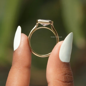 Back View of Radiant Cut Moissanite Solitaire Engagement Ring In two fingers