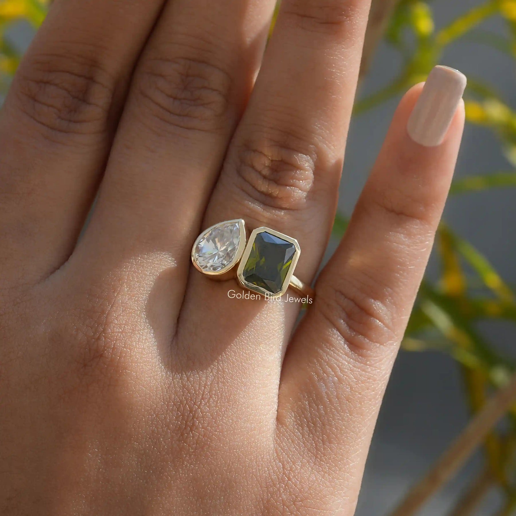 [Two stone moissanite ring crafted with colorless pear & green radiant cut stones]