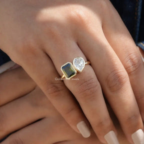 Detailed View Of Moissanite Pear And Radiant Cut Bezel Set Ring In Yellow Gold