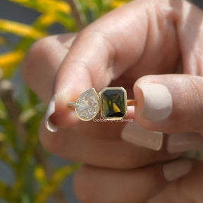 Front View of Radiant And Pear Cut Moissanite Ring In two Fingers
