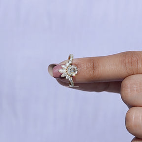 In finger front view of Round Shaped Moissanite Curved Ring In Yellow Gold