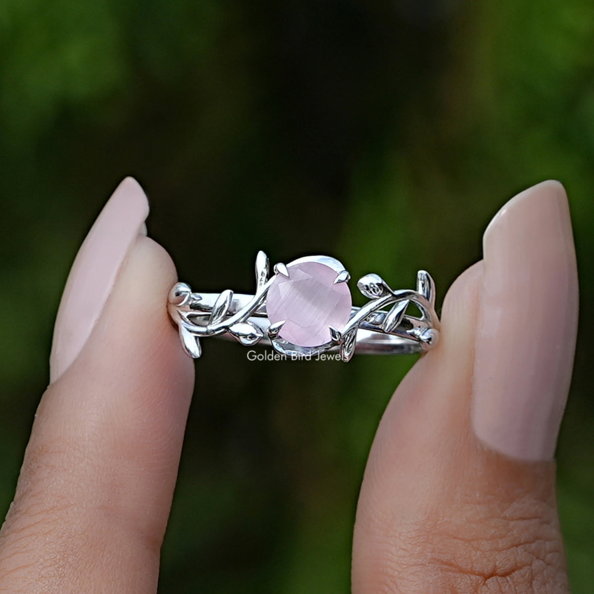 Front View of Rose Quartz Round Gemstone Leaf Style Ring In two Fingers