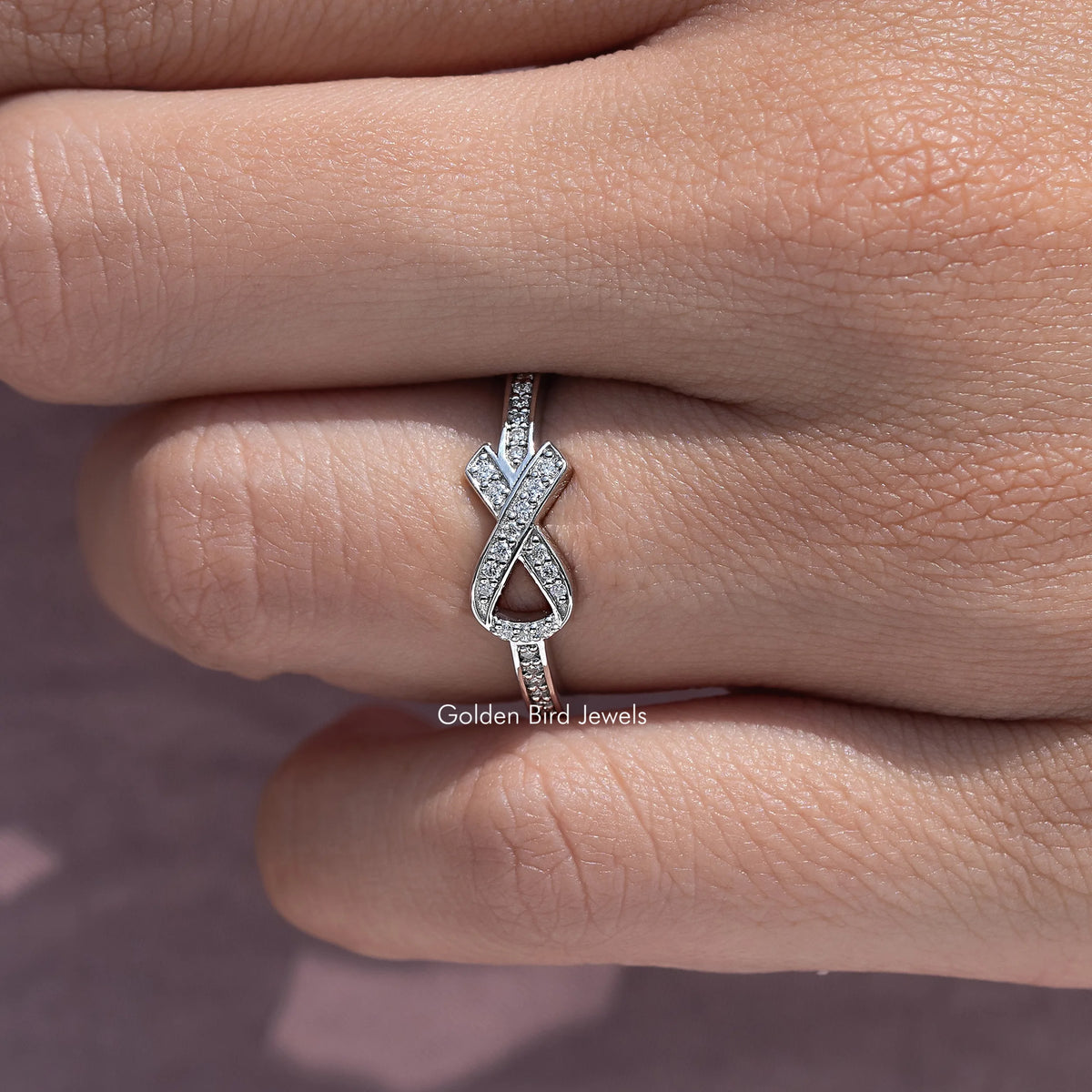 Round-cut stone hope ring with X-style centerpiece on a silver band