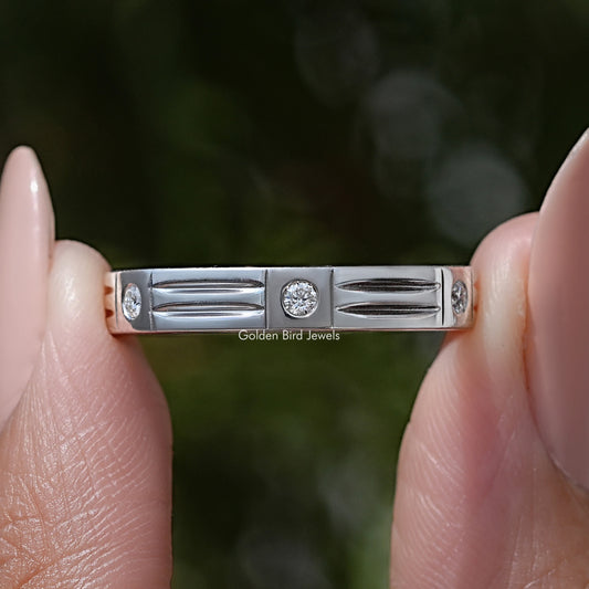 Silver wedding band with rectangular row and round moissanite stones, close-up
