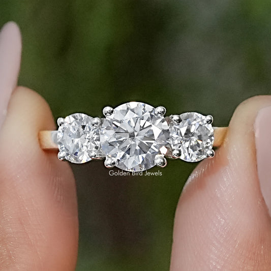 Three-stone round moissanite ring in silver with prong-set center and side stones