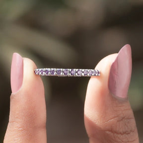 Two fingers holding the Round Cut Amesthyst Gemstone Half Eternity Band