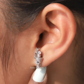 In ear side view of studs earings in 4 round moissanite