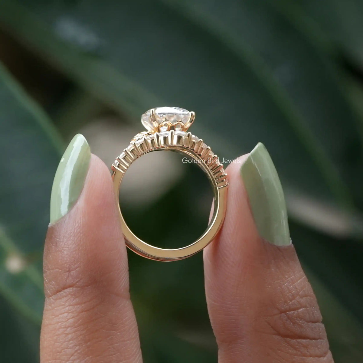 Back View of Round Cut Moissanite Accent Stone Ring In two fingers