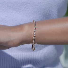 View of Round Cut Diamond Tennis Bracelet In Hand