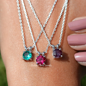 Hand Showing View Of Round Cut Gemstone Solitaire Pendant