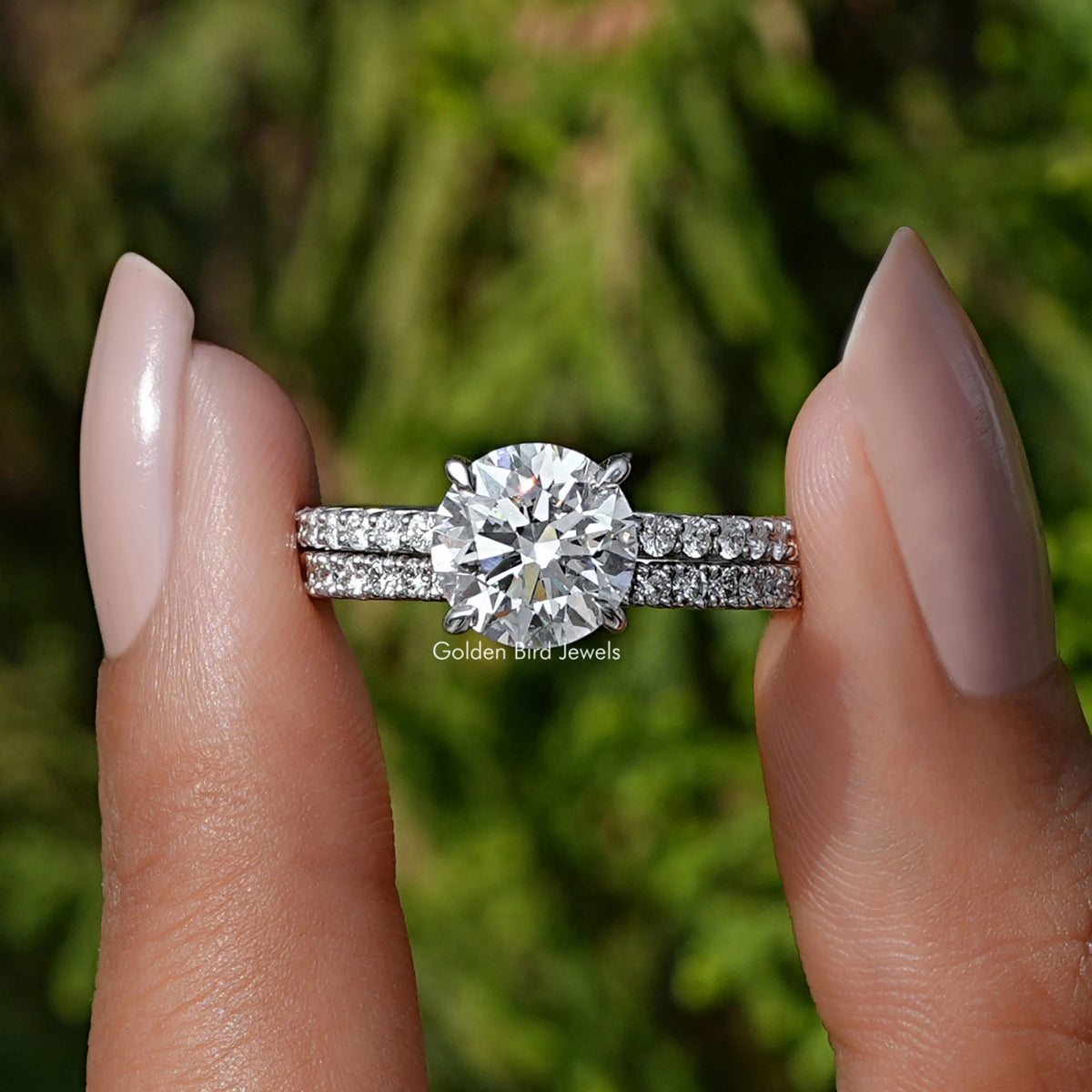 Front View of A Round Cut Lab Diamond Wedding Ring In two fingers
