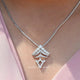 View of round cut moissanite solitaire pendant 