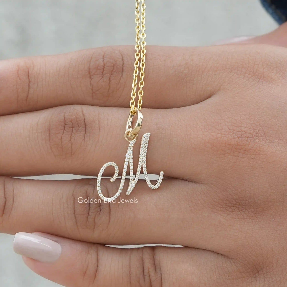 View of round cut moissanite custom letter pendant
