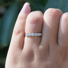 [In finger front view of round cut eternity wedding band in rose gold]-[Golden Bird Jewels]
